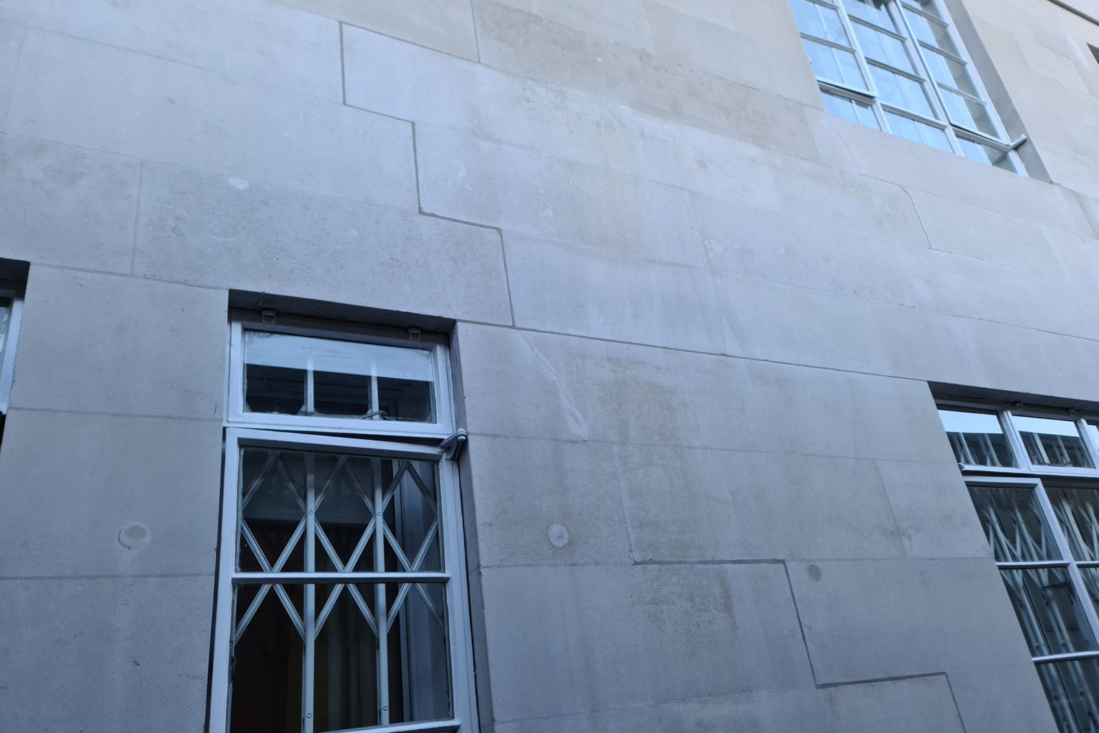 Repaired stone ashlar and redecorated metal windows