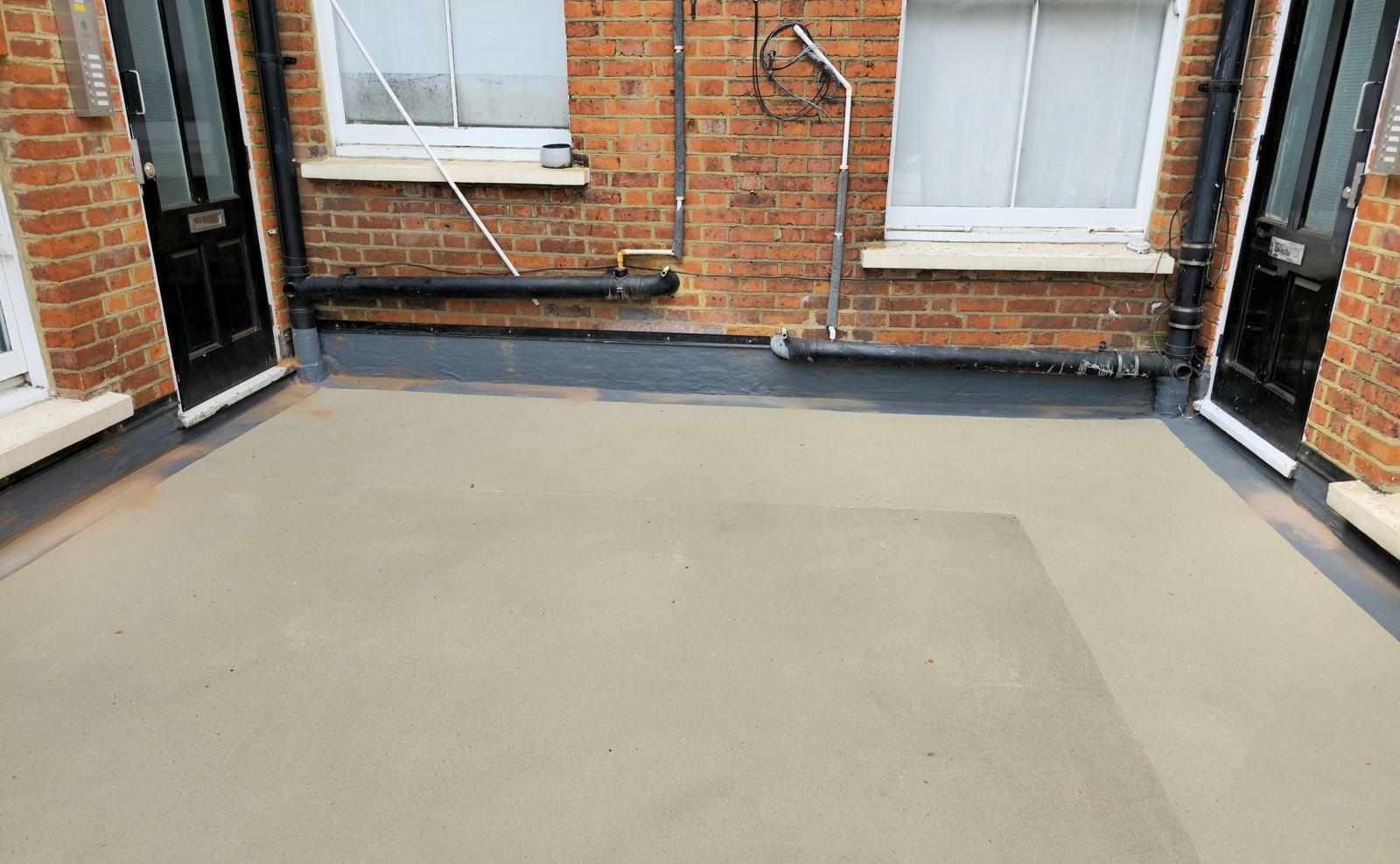 Renewed rear roofs over a supermarket with flats above, after completion