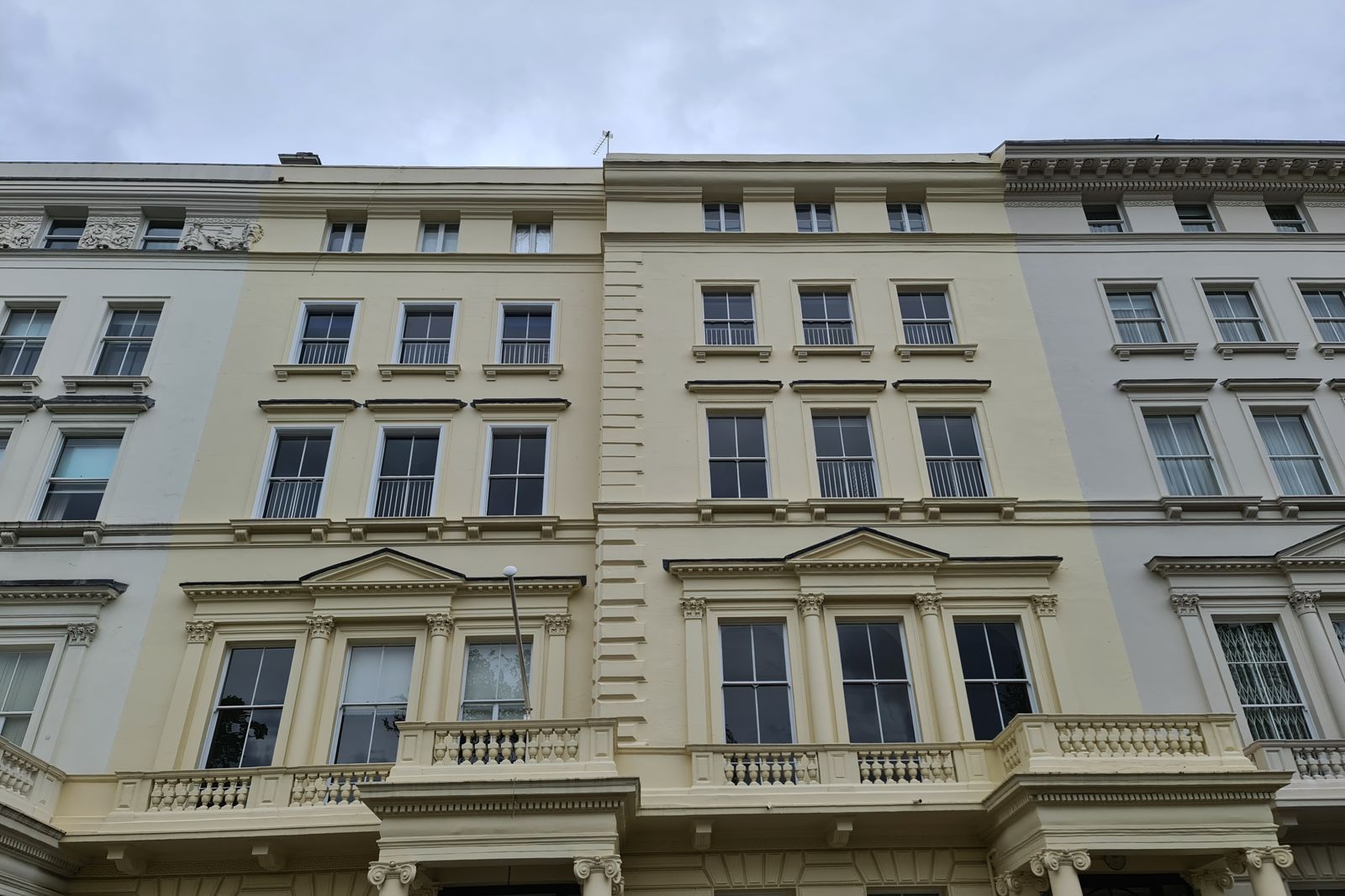 Repaired and redecorated Grade II listed stucco terrace front elevation in Westminster