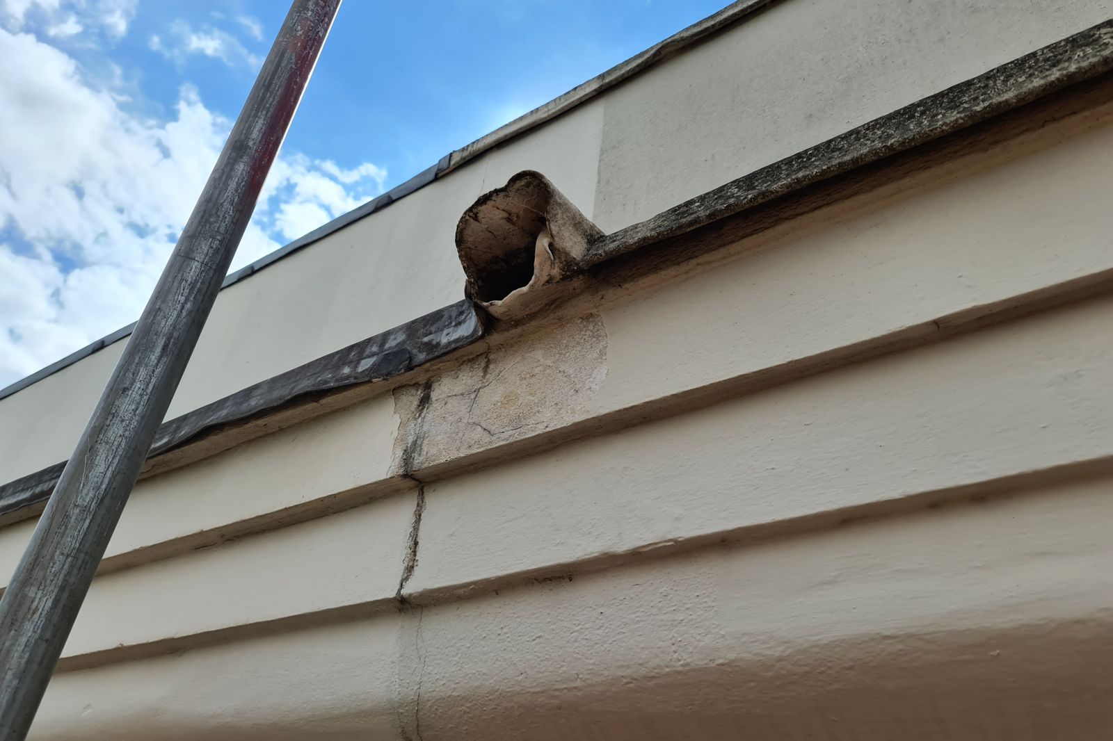 Cracked cornice exposed from the scaffold