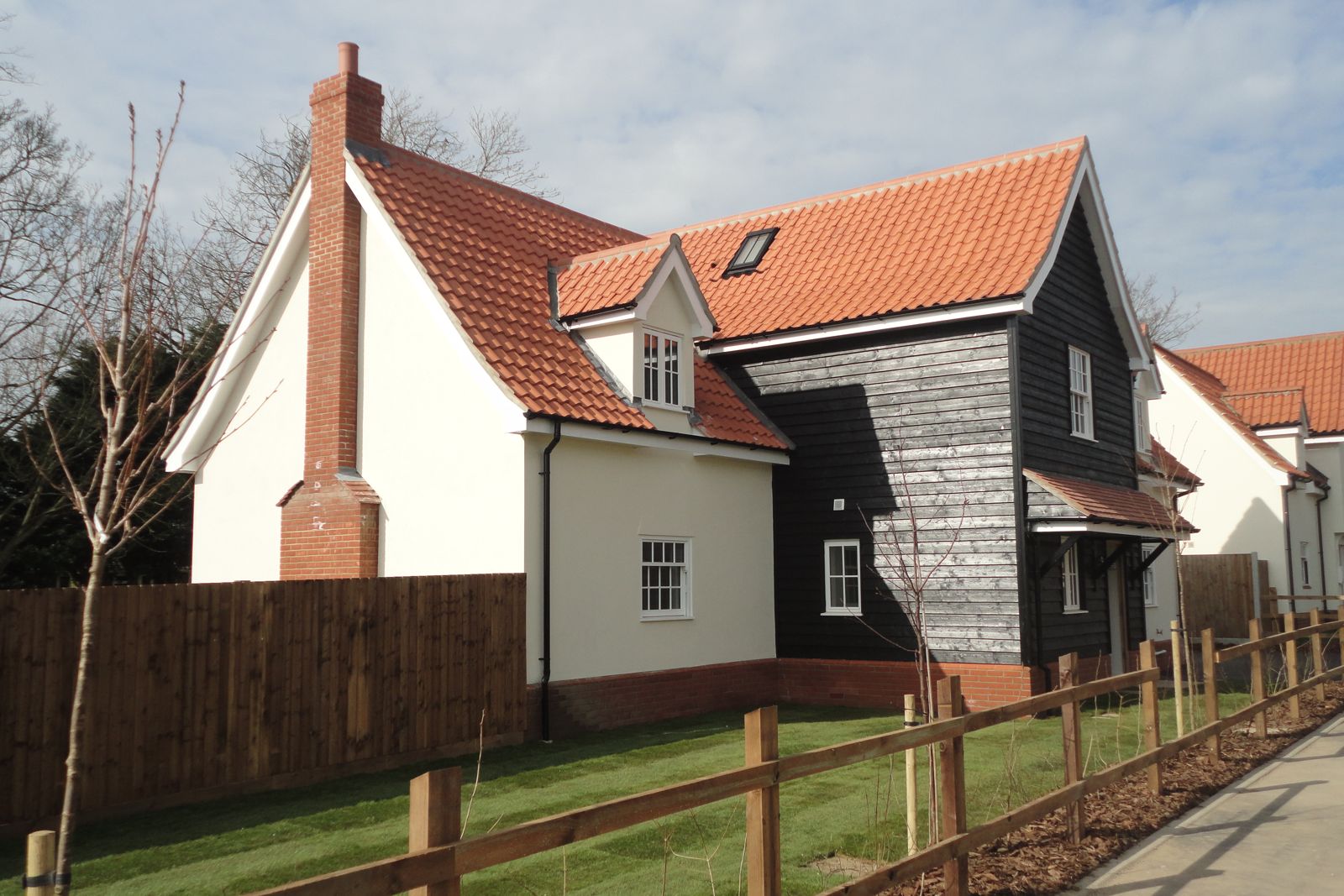 Completed detached new build house with pantile roof and black weatherboarding in East Anglia