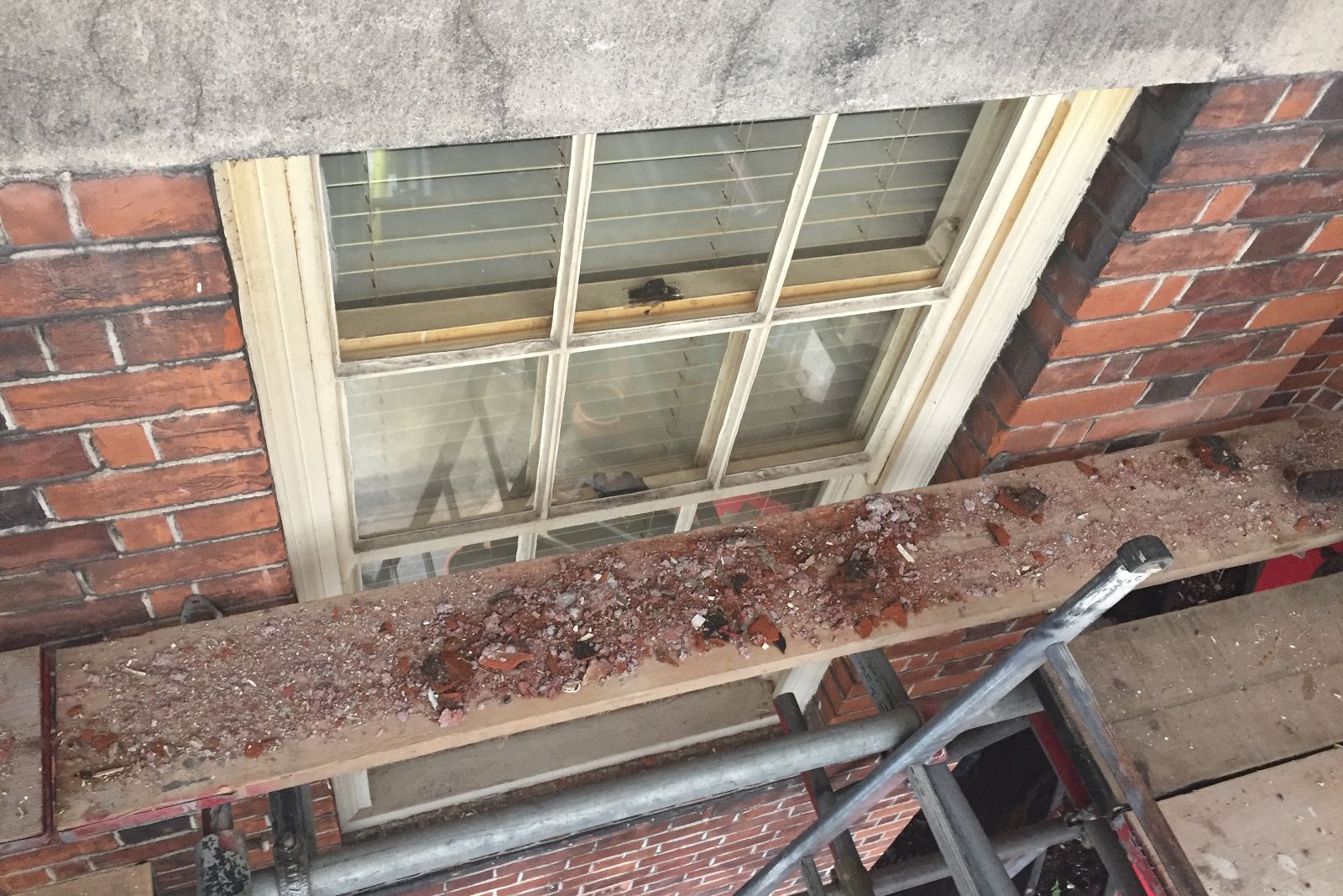 Decayed window cill exposed from the scaffold before repair