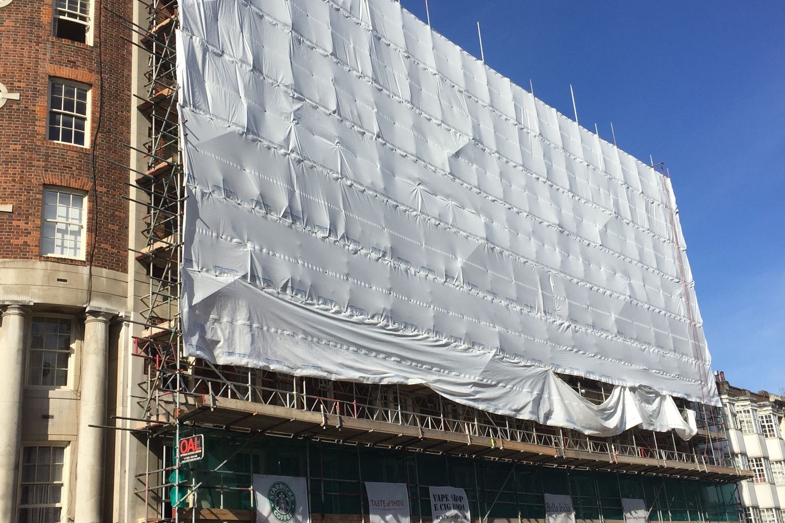 Fully sheeted scaffold over trading shopfronts